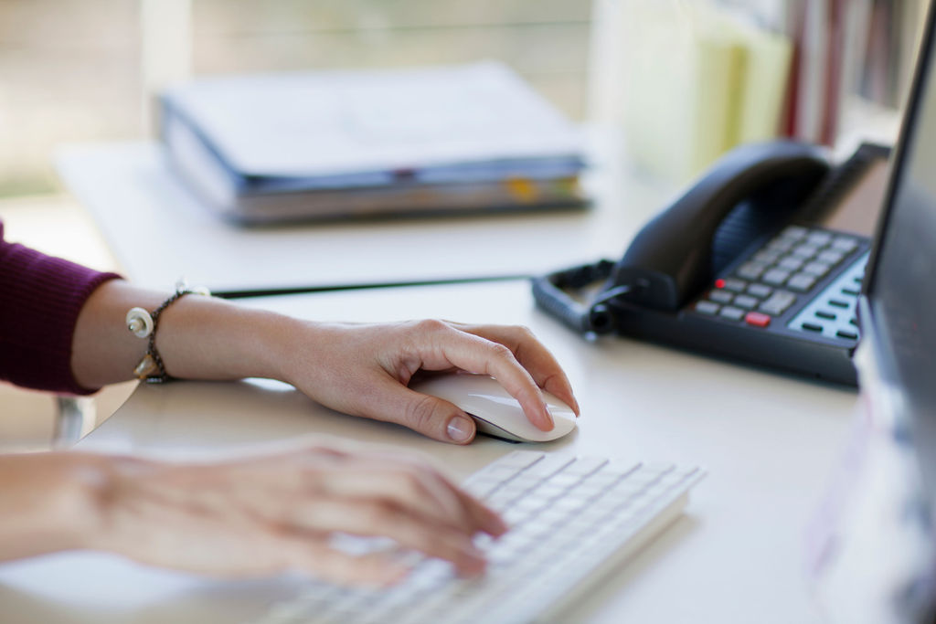 Person using a mouse and keyboard