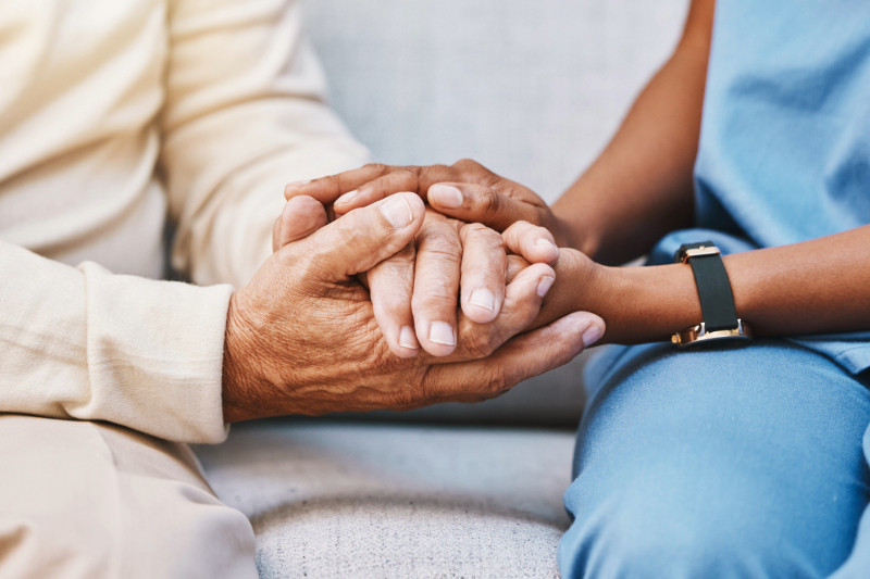 Provider holding patient's hand.